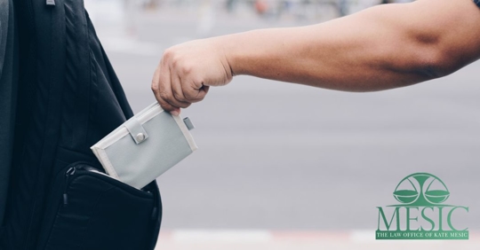 man stealing a wallet from a bag